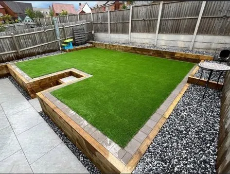 a backyard with a grass lawn and a wooden bench