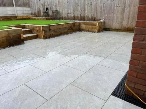 a backyard with a grass area and a brick wall