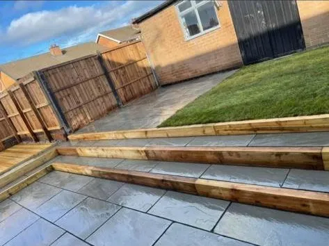 a backyard with a wooden fence and steps