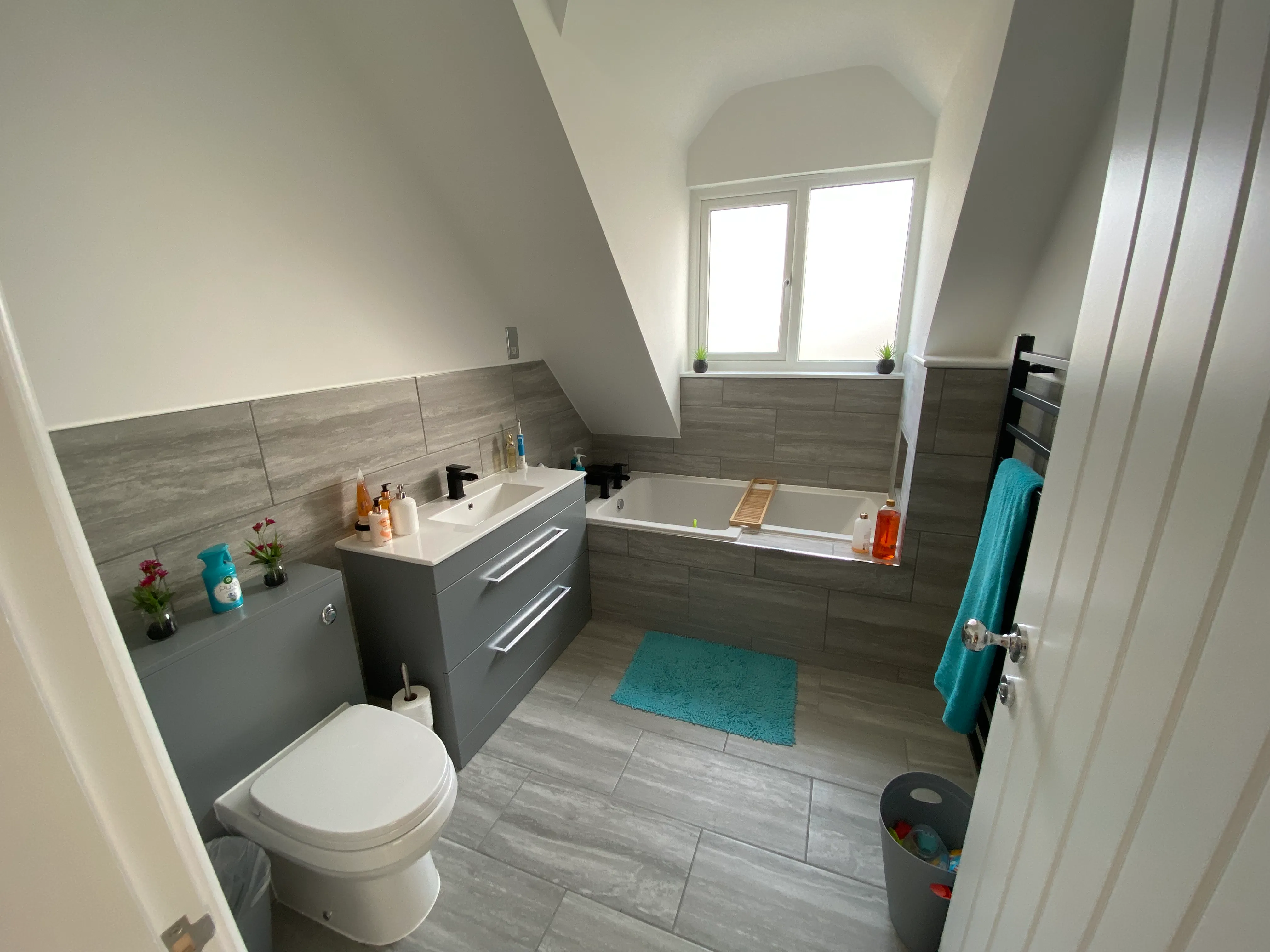a bathroom with a toilet, sink, and bathtub