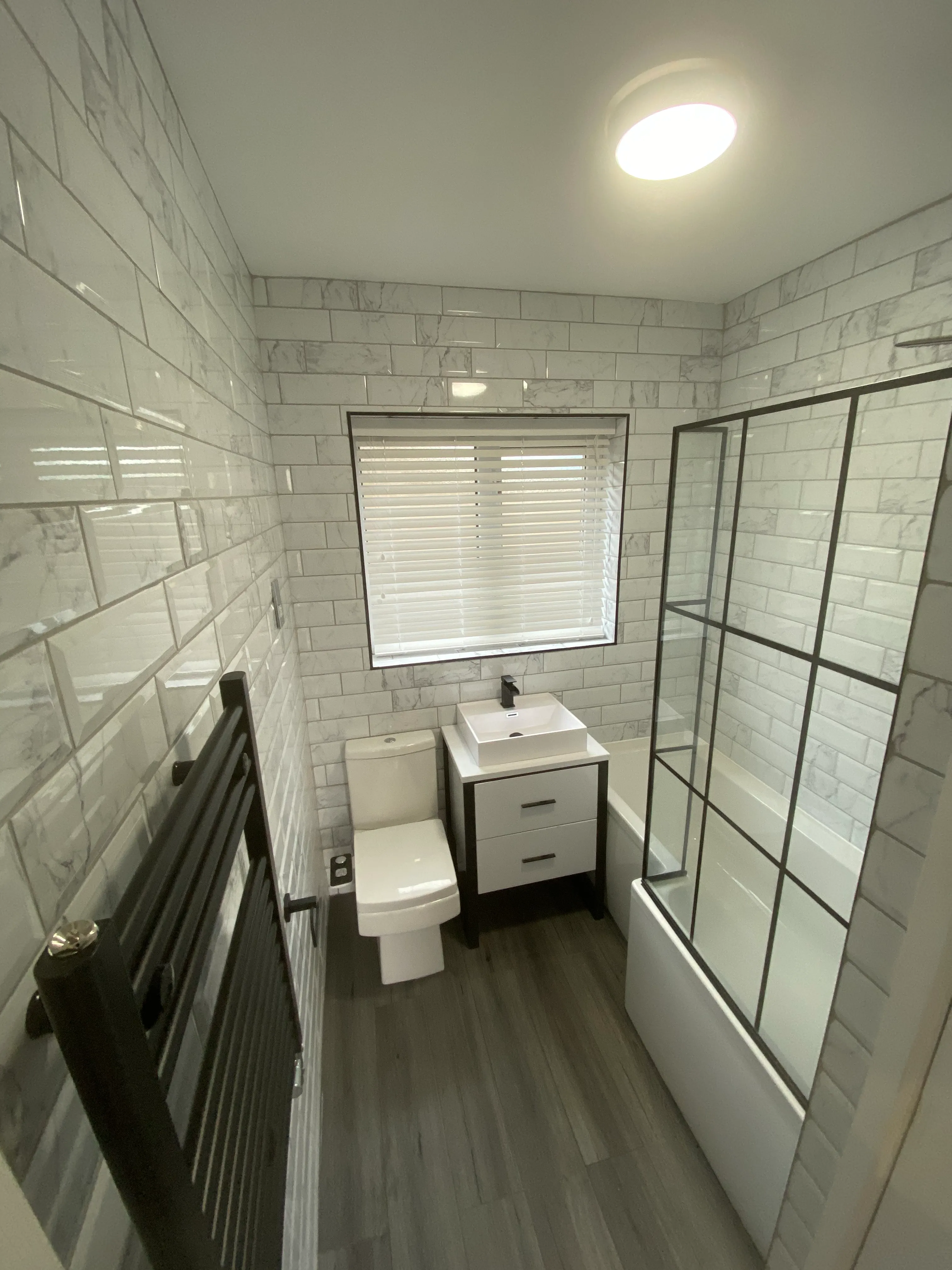 a bathroom with a toilet, sink, and shower