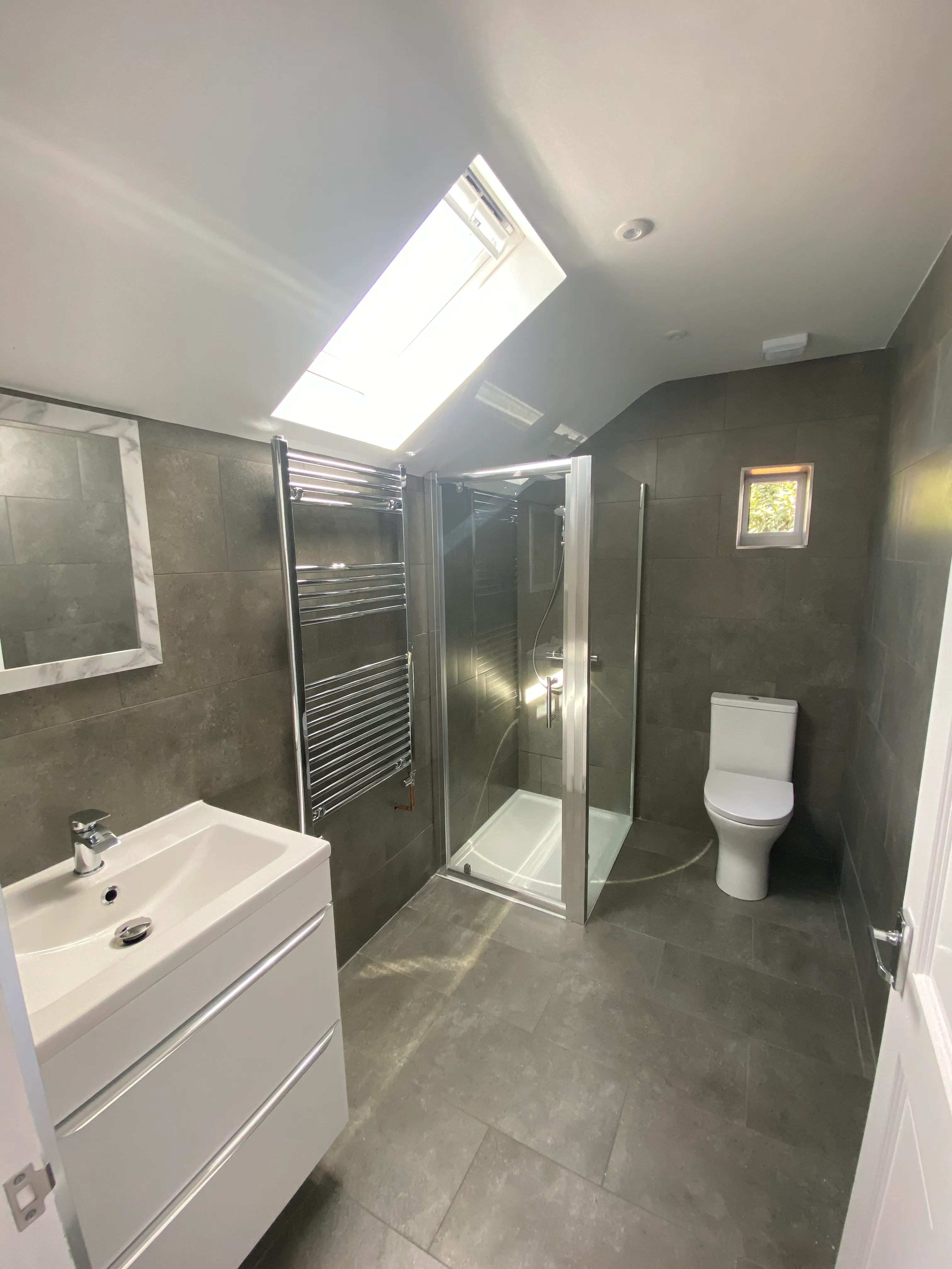 a bathroom with a sink, toilet, and shower