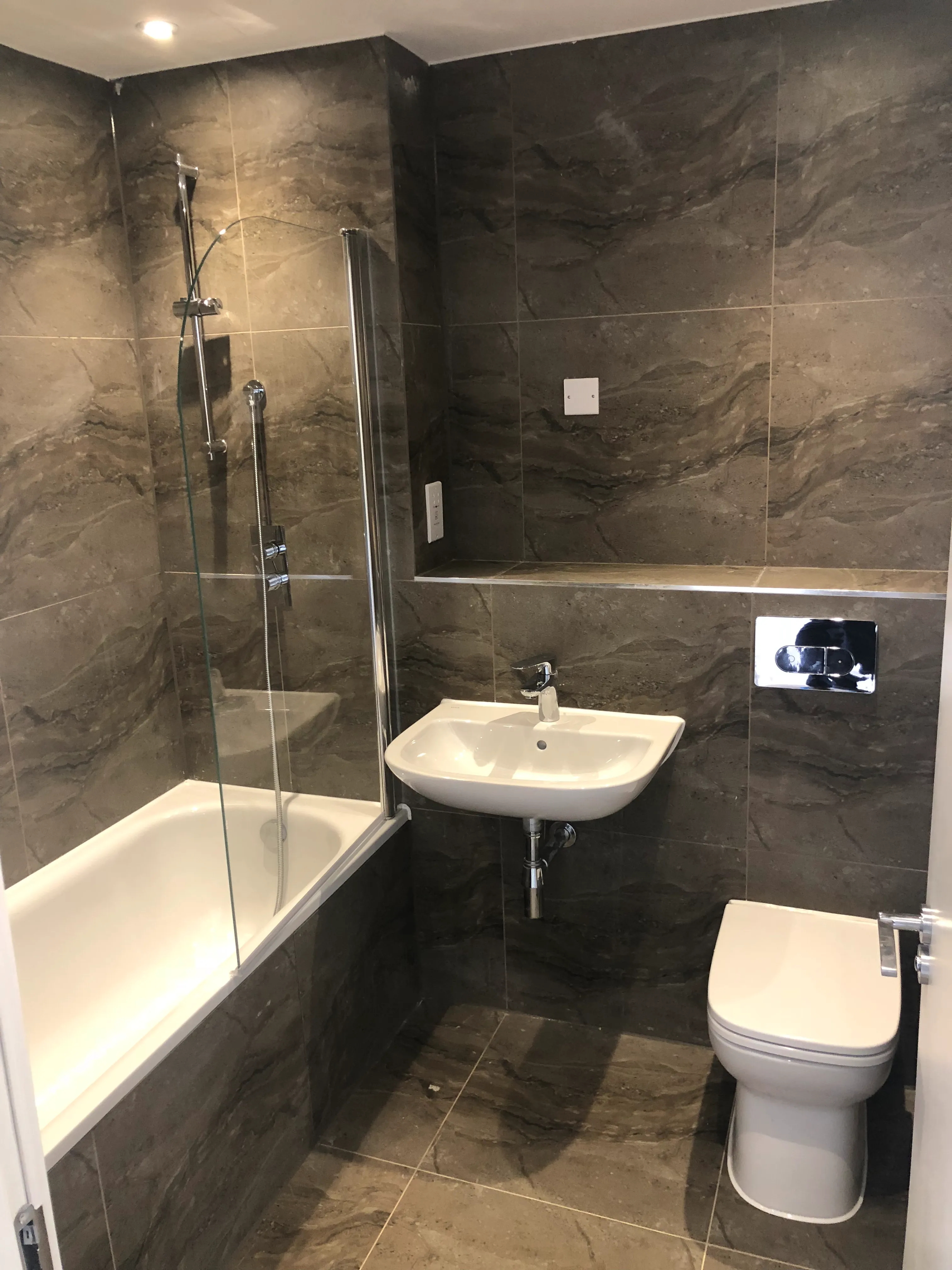 a bathroom with a toilet, sink, and bathtub