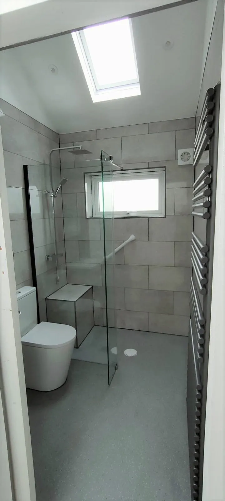 a bathroom with a toilet and a shower stall