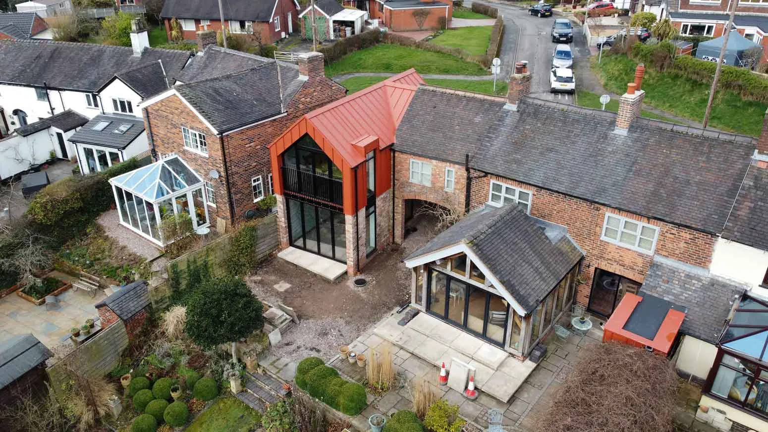 an aerial view of a house with a red roof