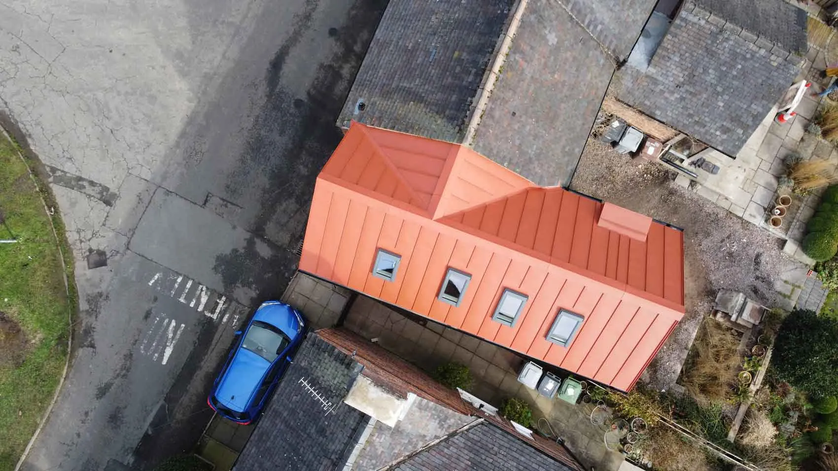 an aerial view of a house with a car parked in front of it
