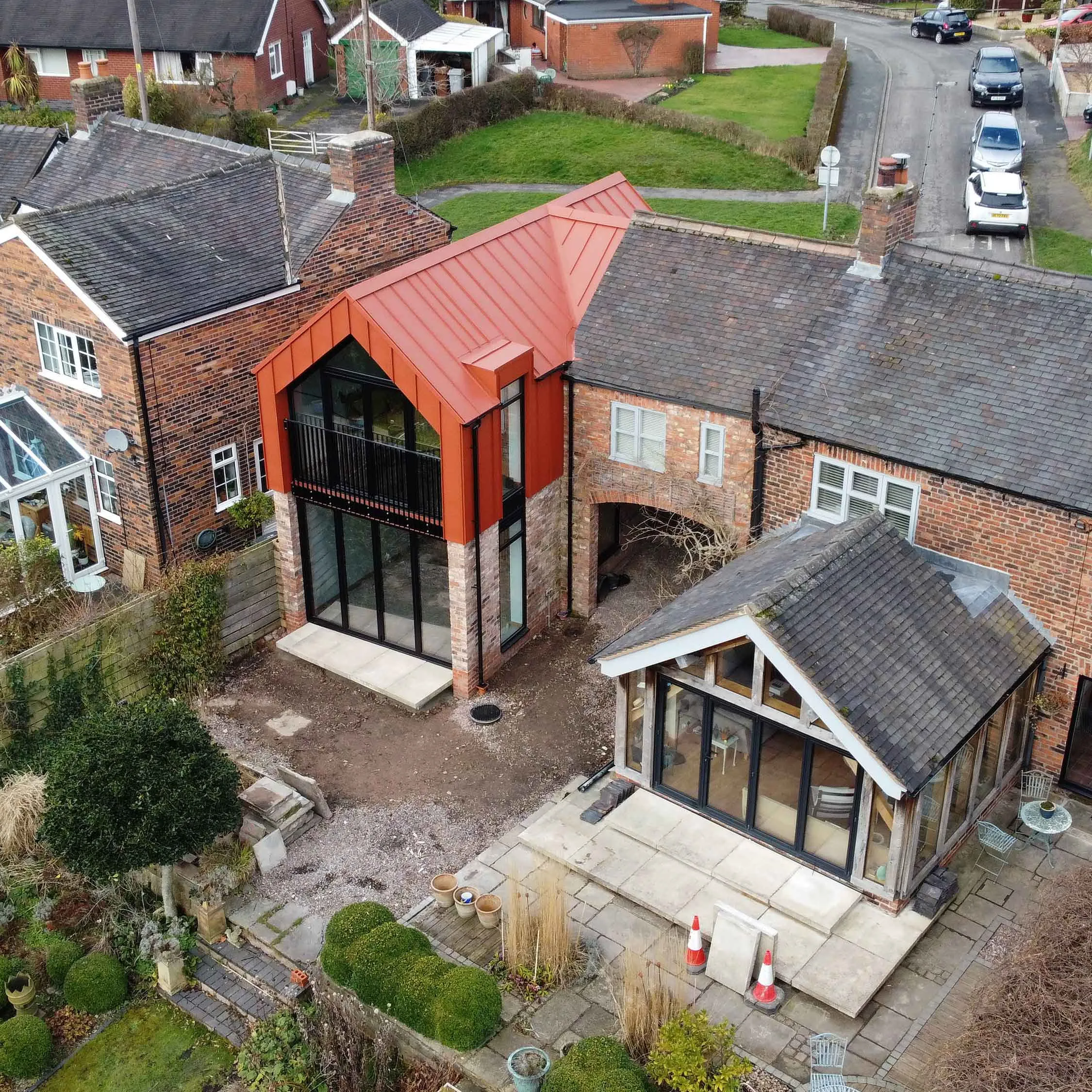 an aerial view of a house with a red roof