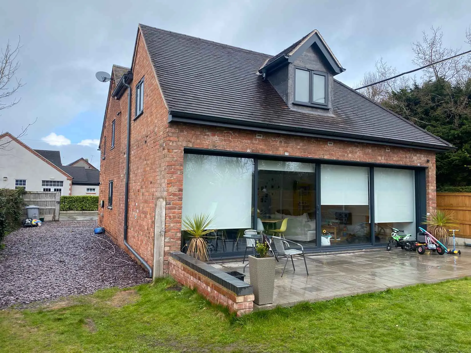 a brick house with a patio and grass