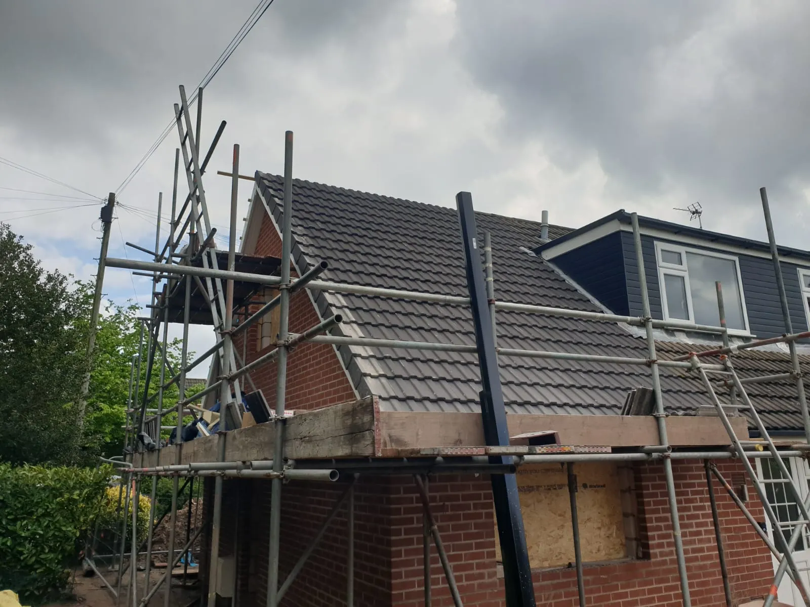 a house under construction with scaffolding on the roof
