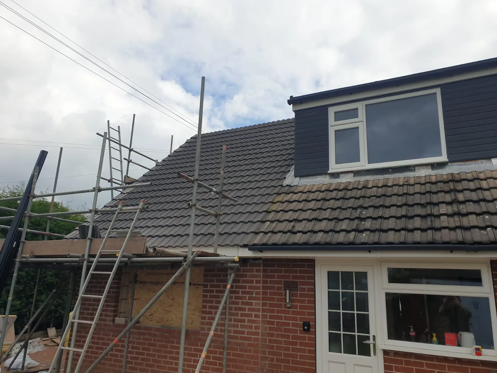 a house with a roof that has a ladder up to it