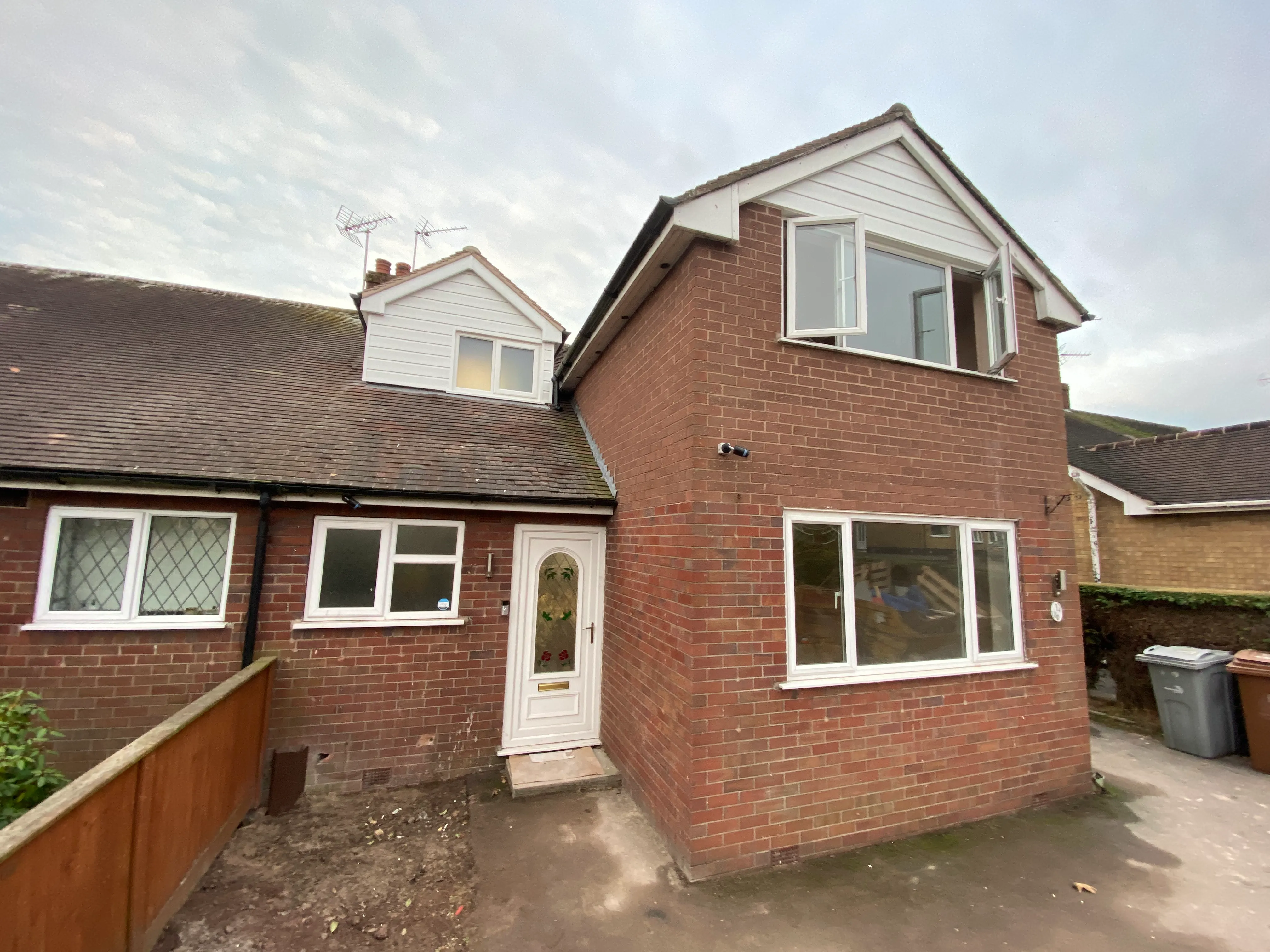a brick house with a white door and windows