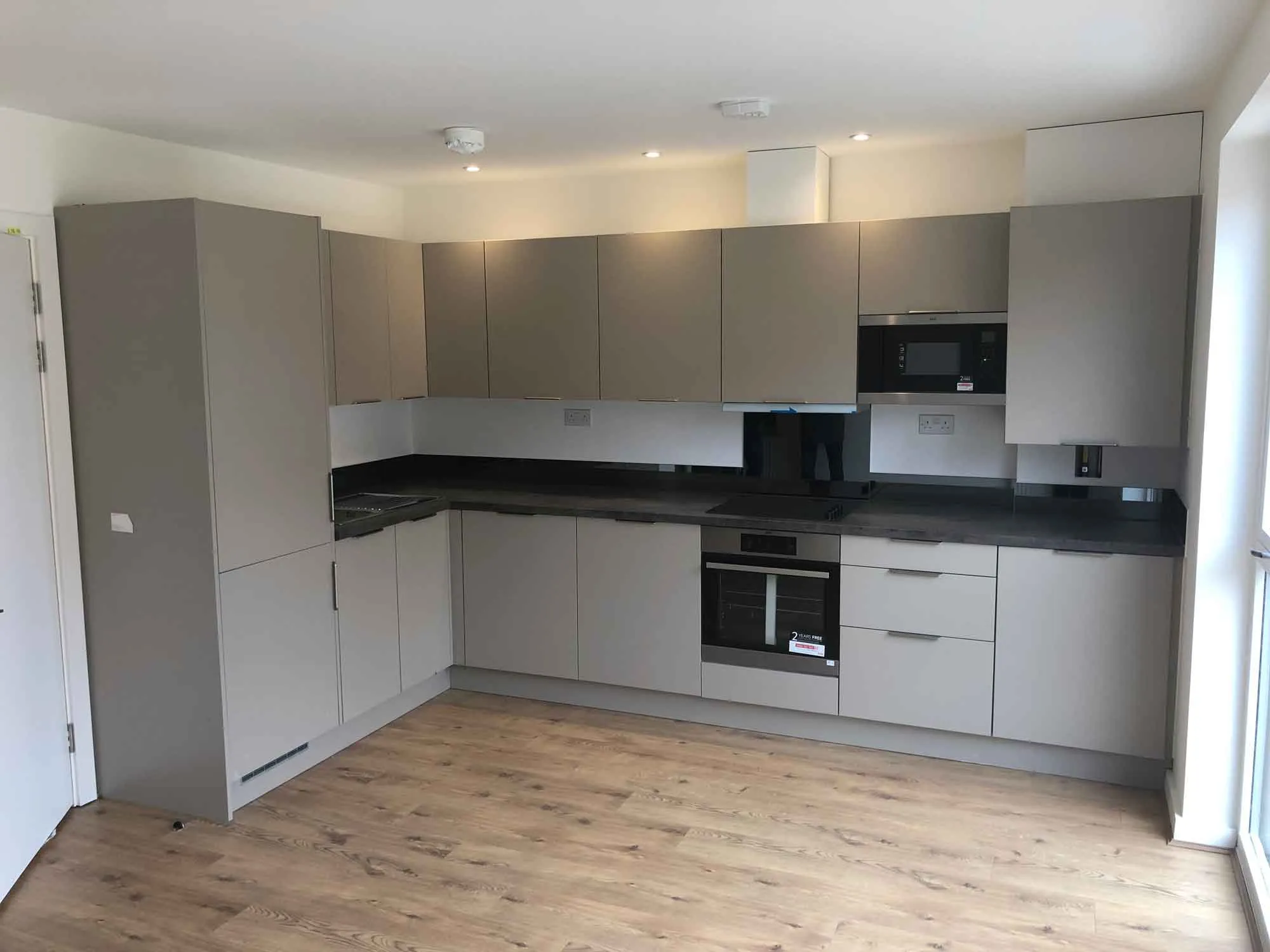 a kitchen with a stove top oven and a microwave