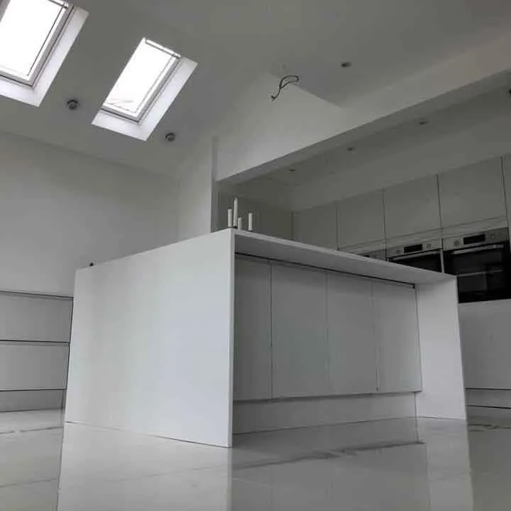 an empty kitchen with a skylight above it