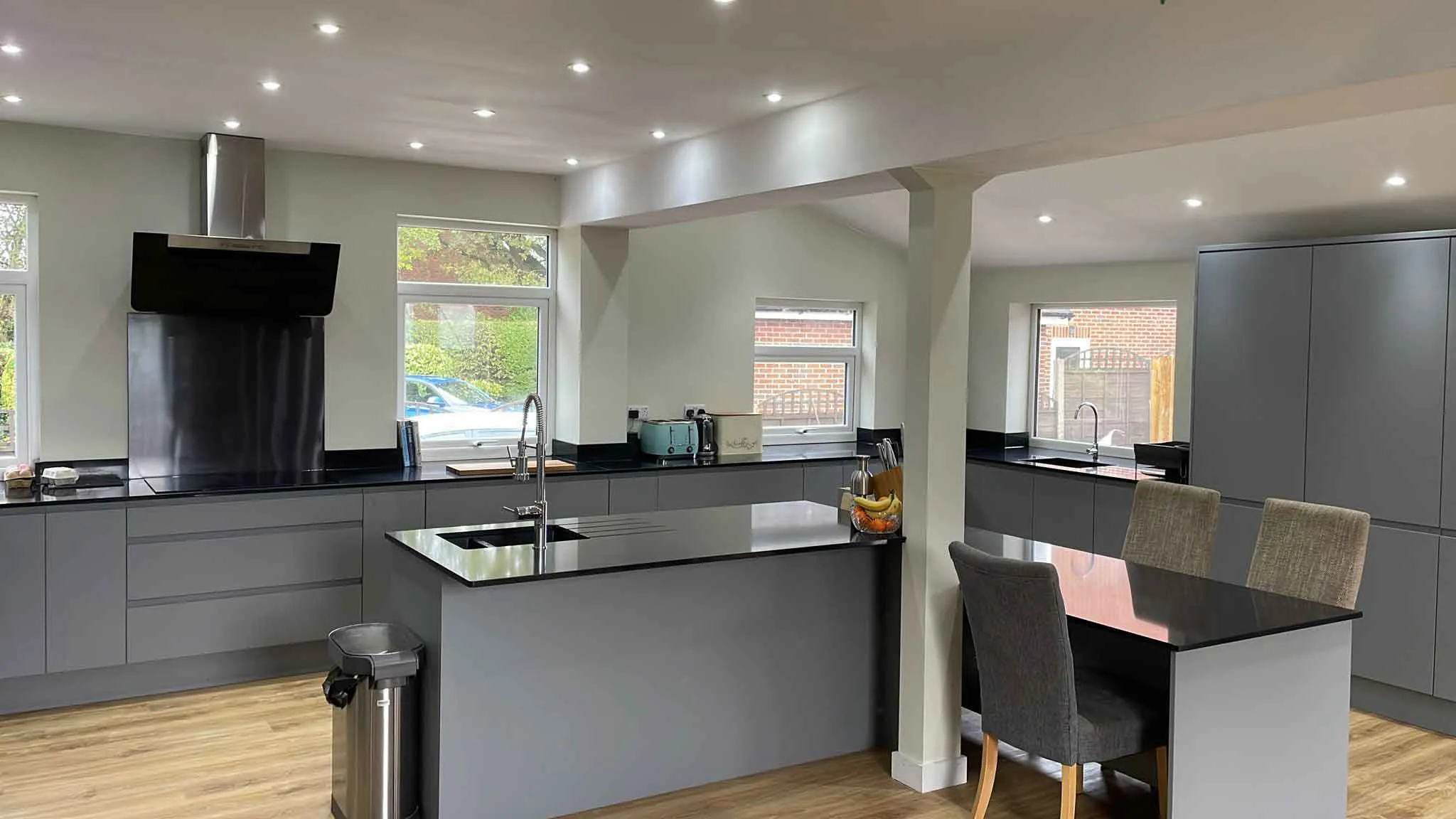 a large kitchen with a center island and stainless steel appliances