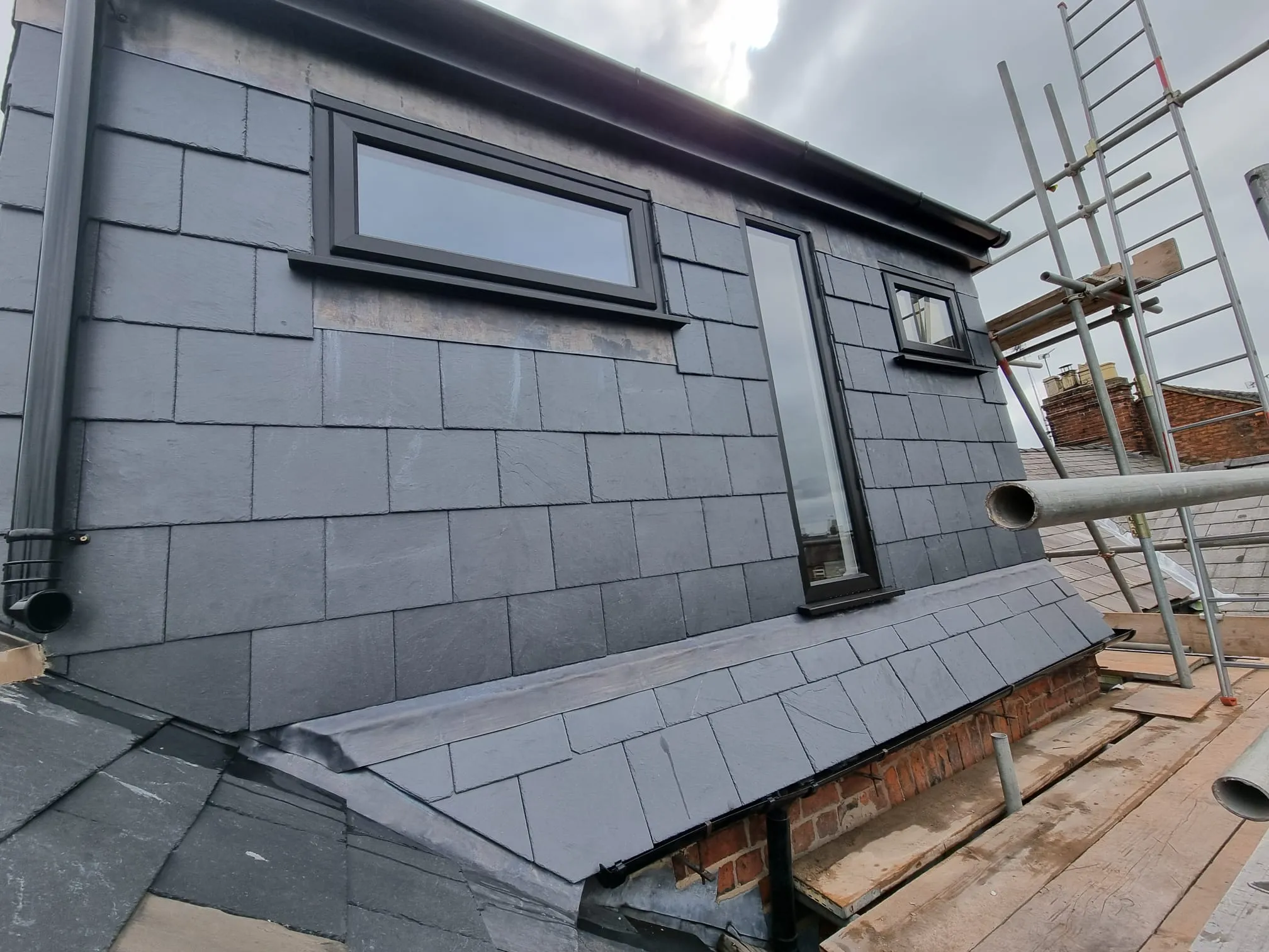 a house with a metal roof and a ladder