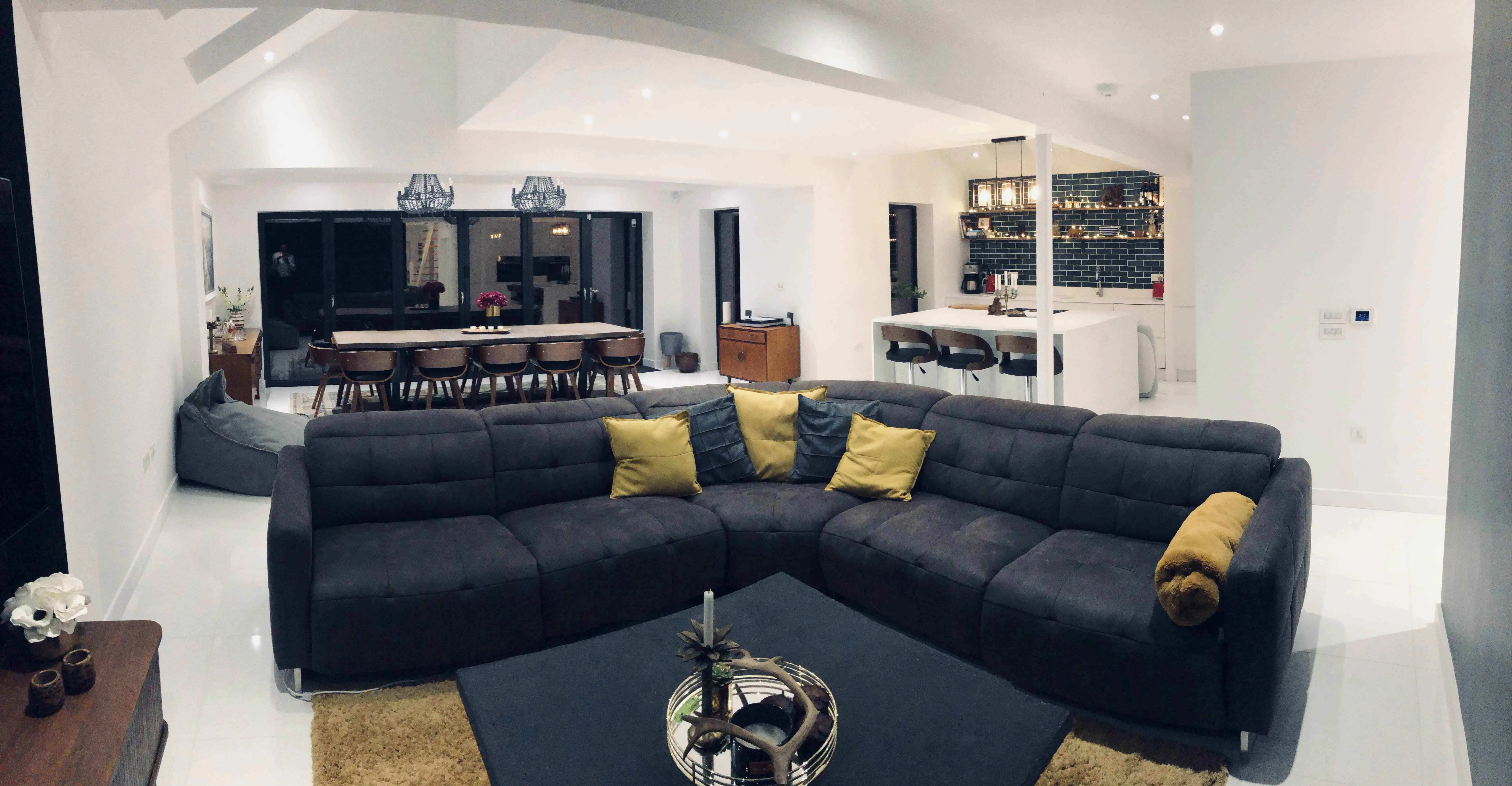 a living room filled with furniture and a bar