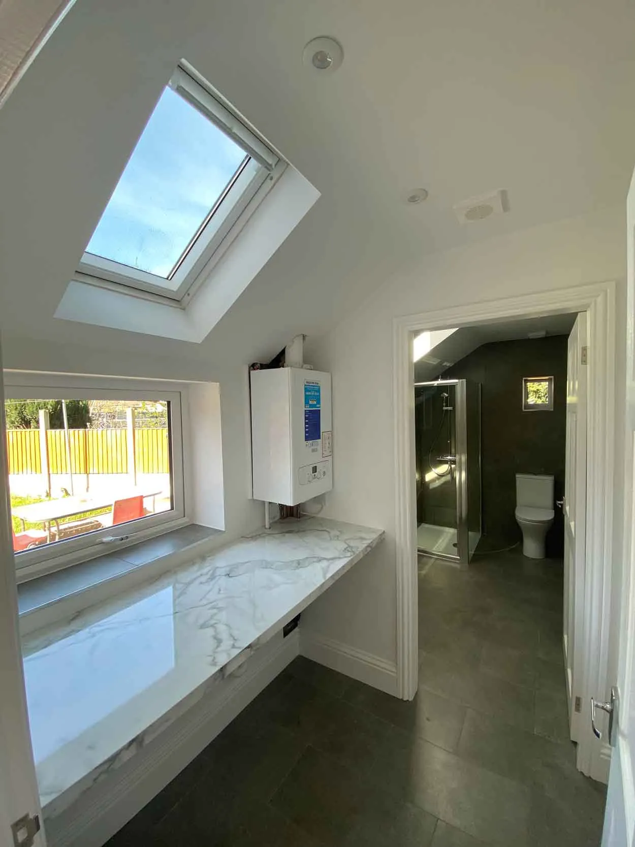 a bathroom with a skylight and a toilet