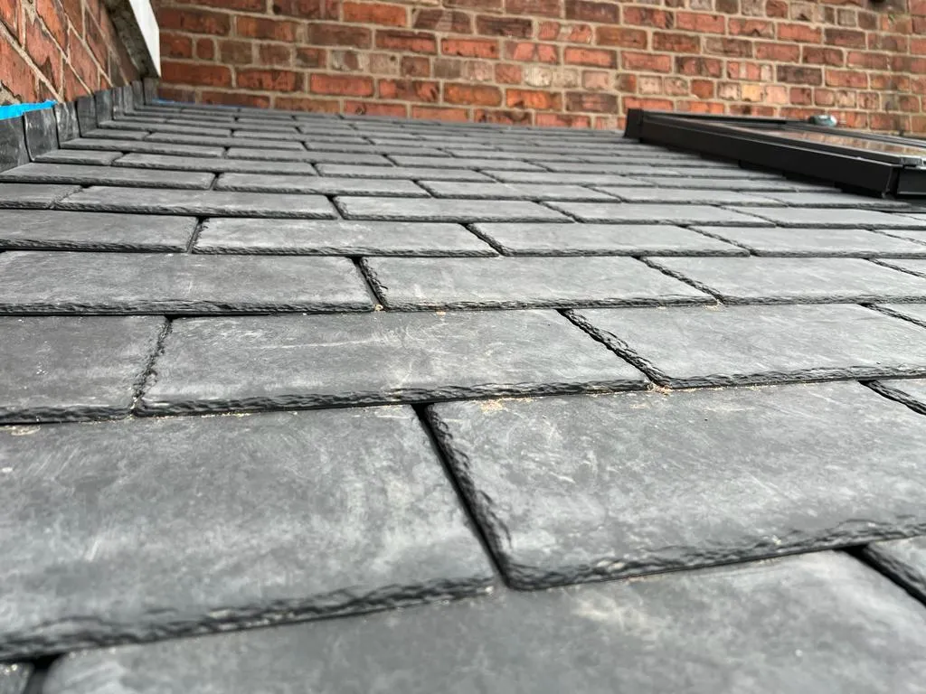 a close up of a brick walkway near a brick building