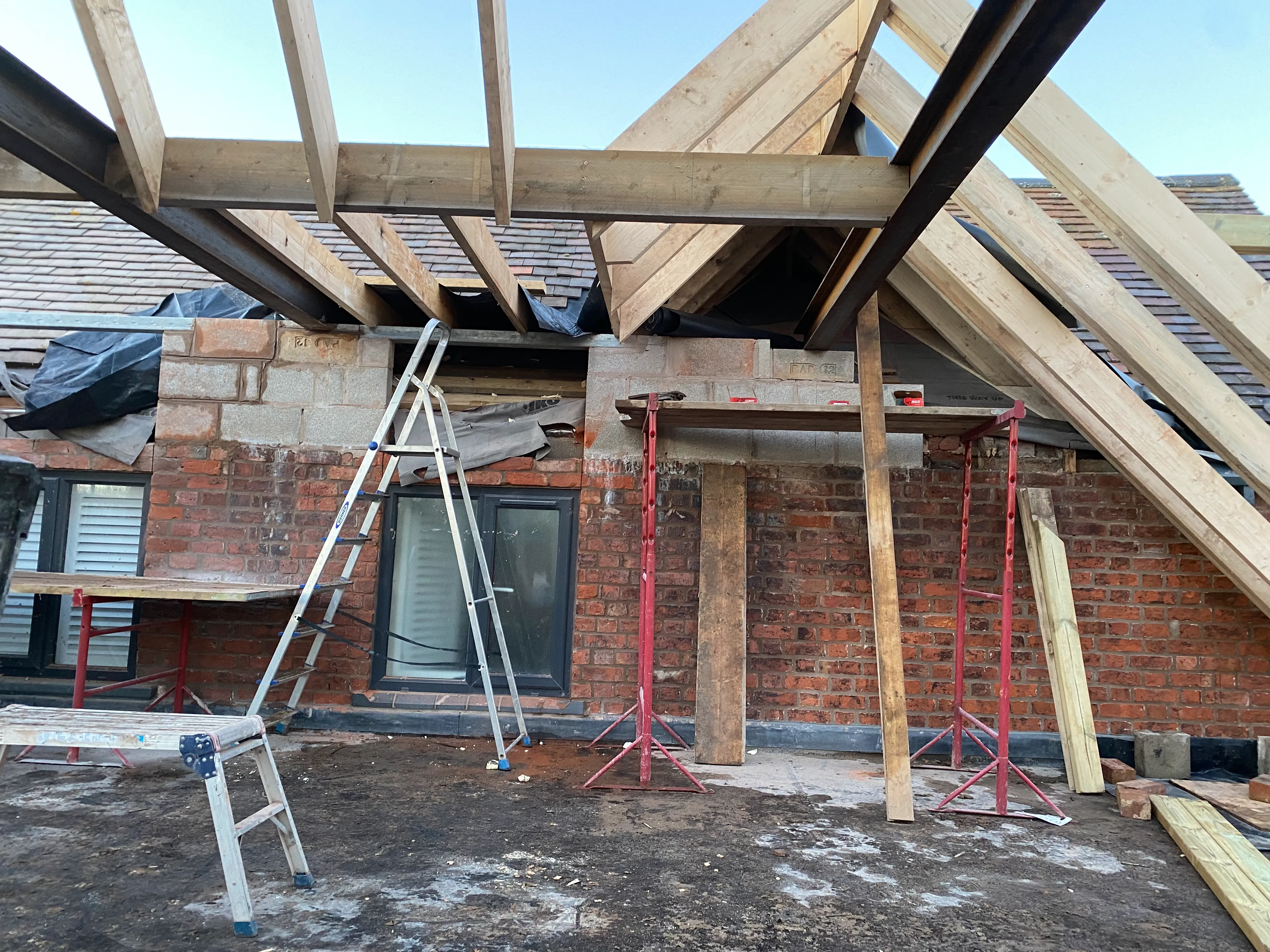 a house under construction with a ladder and ladder