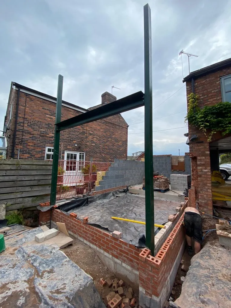 a brick building with a metal beam sticking out of it