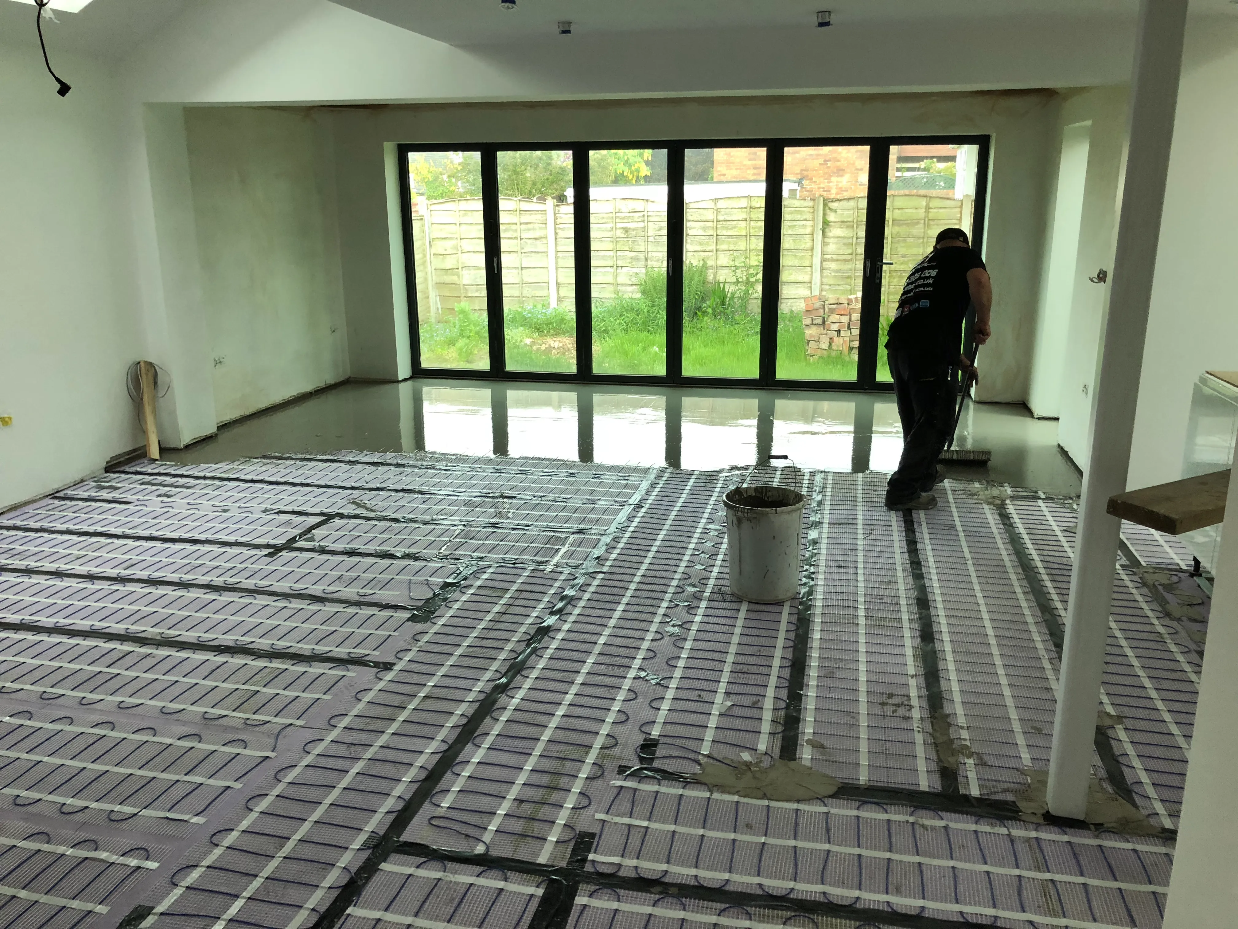 a person standing in a room that is under construction
