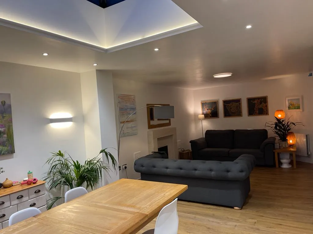 a living room filled with furniture and a wooden table