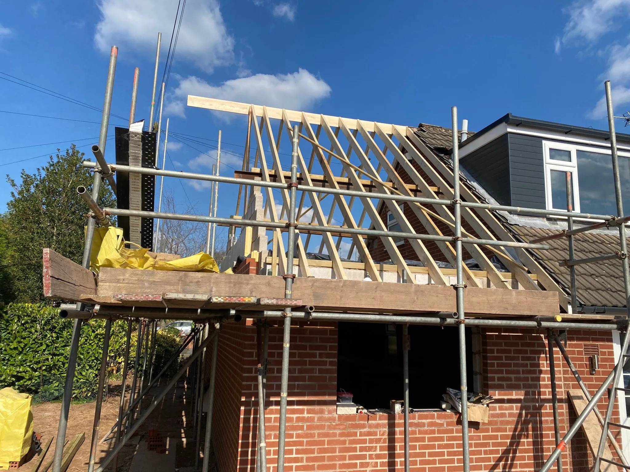 a house under construction with scaffolding on the roof