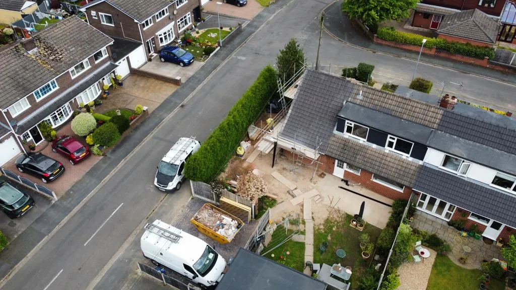 an aerial view of a residential area with cars parked in the driveway
