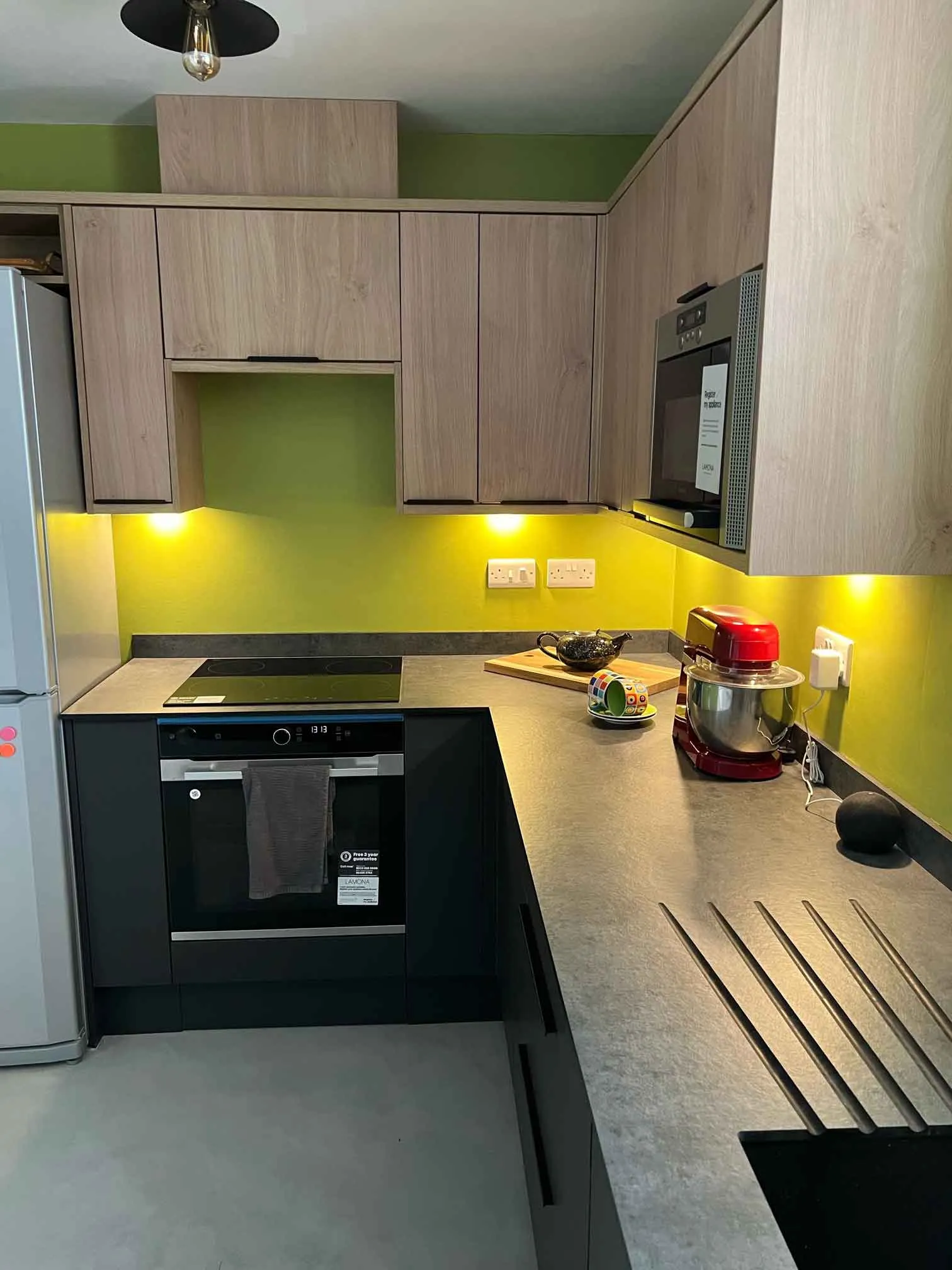 a kitchen with a stove top oven next to a refrigerator