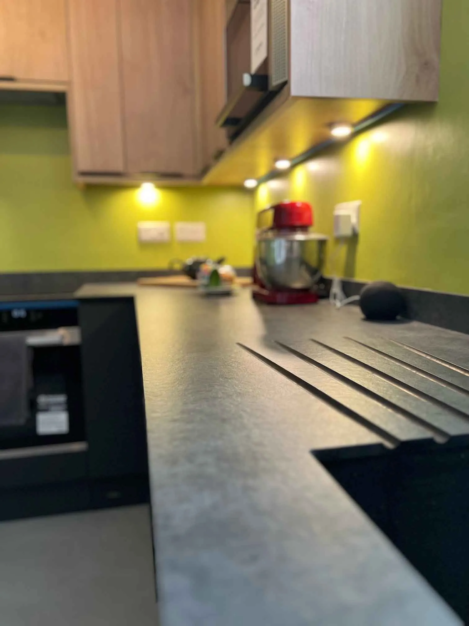 a kitchen with a stove top oven next to a counter