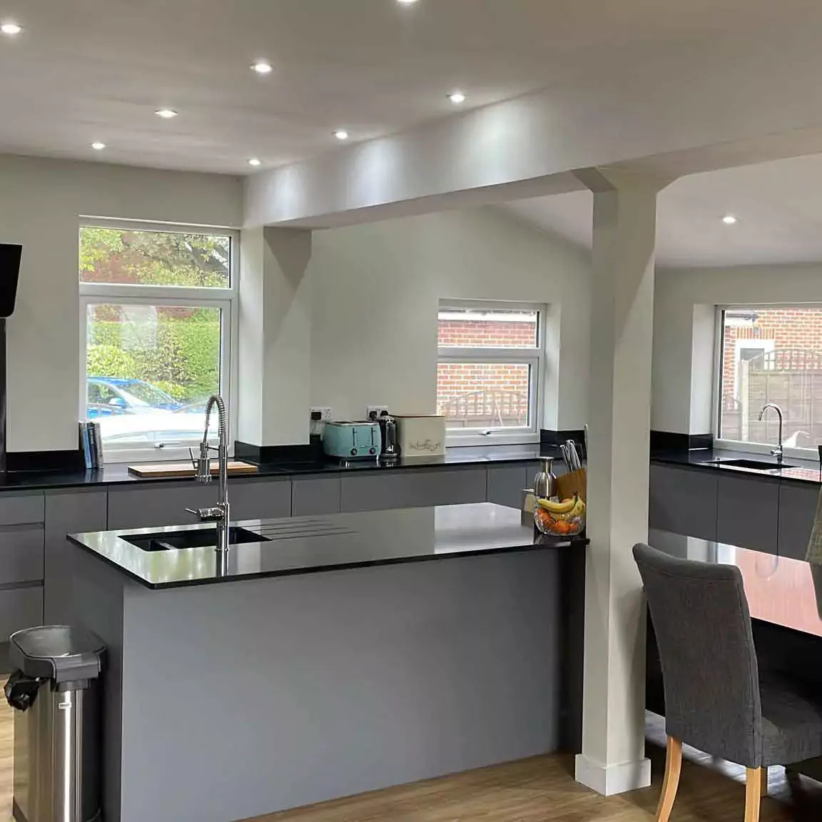 a modern kitchen with a large island and stainless steel appliances