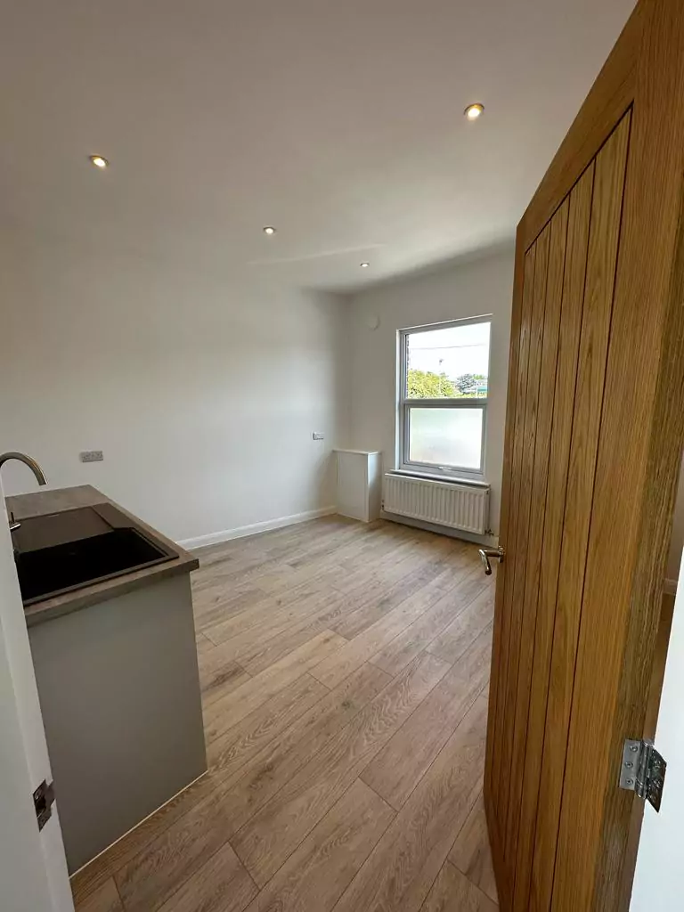 an empty room with a sink and a window