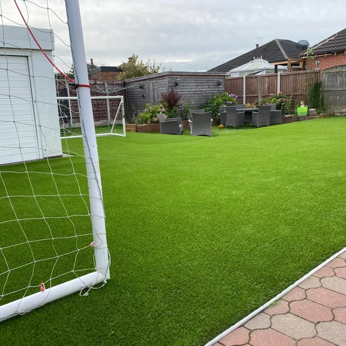 a soccer field with a soccer goal and a soccer ball