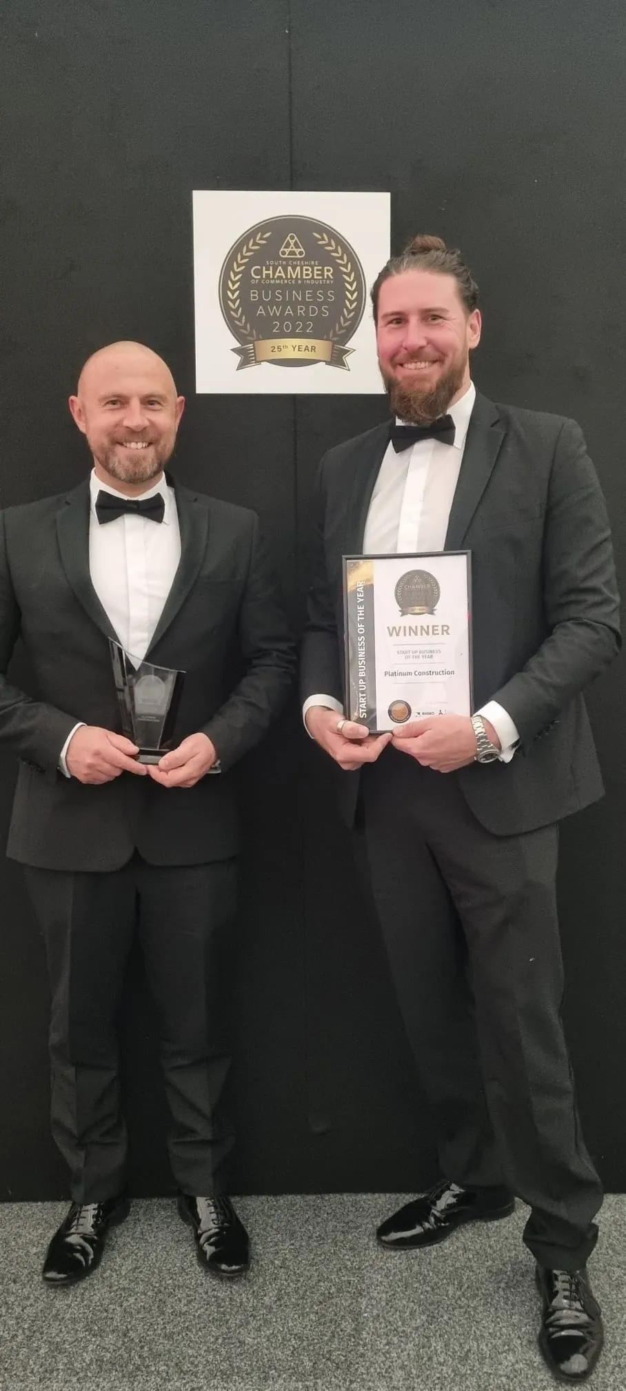 two people posing with an award