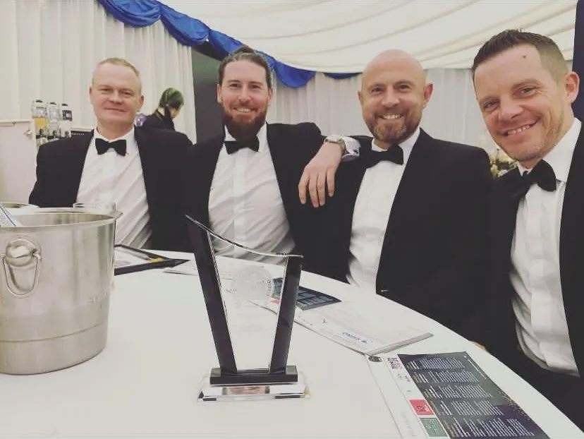 people in suits sitting at a table