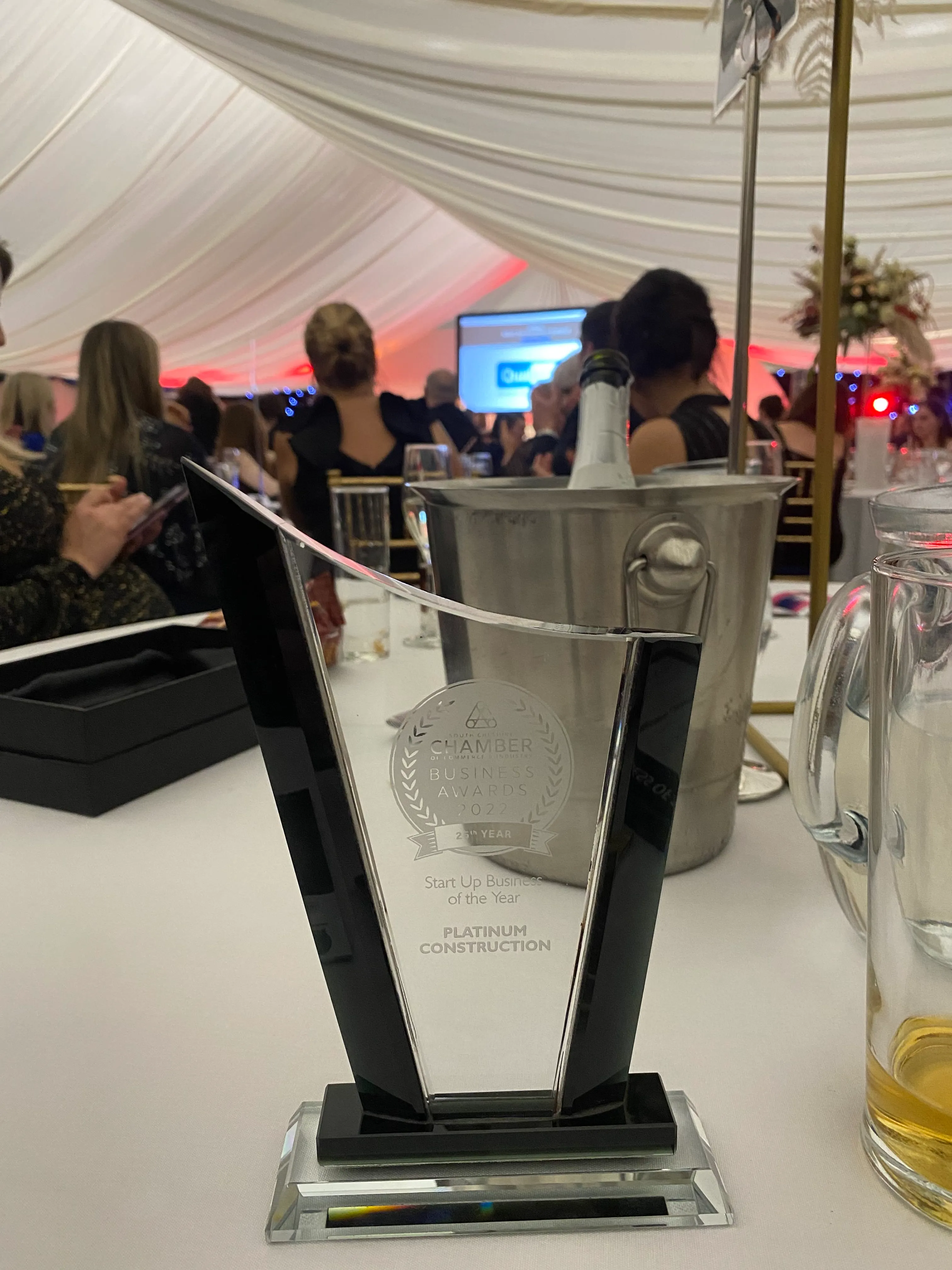 a glass trophy sitting on top of a white table