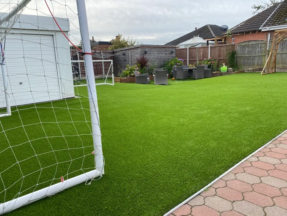 a soccer goal and a soccer ball on a grass field
