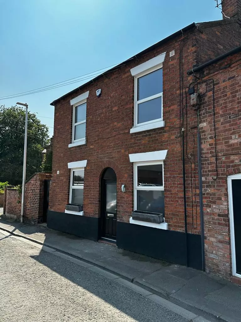 a brick building with a black door and windows